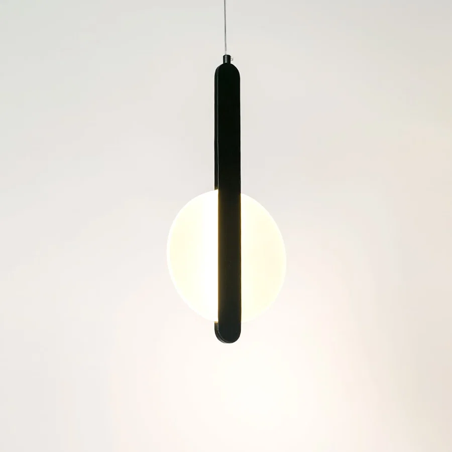 Illuminated black linear pendant light with frosted diffuser creating soft ambient lighting indoors.