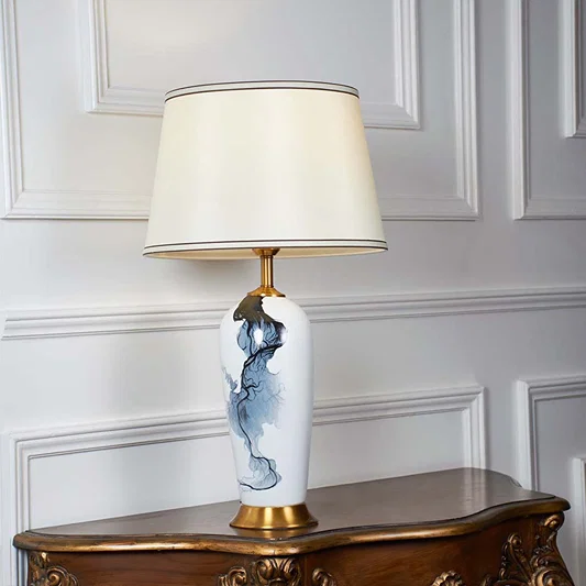 Blue and white floral ceramic table lamp with fabric shade designed for elegant traditional decor and ambient table lighting.