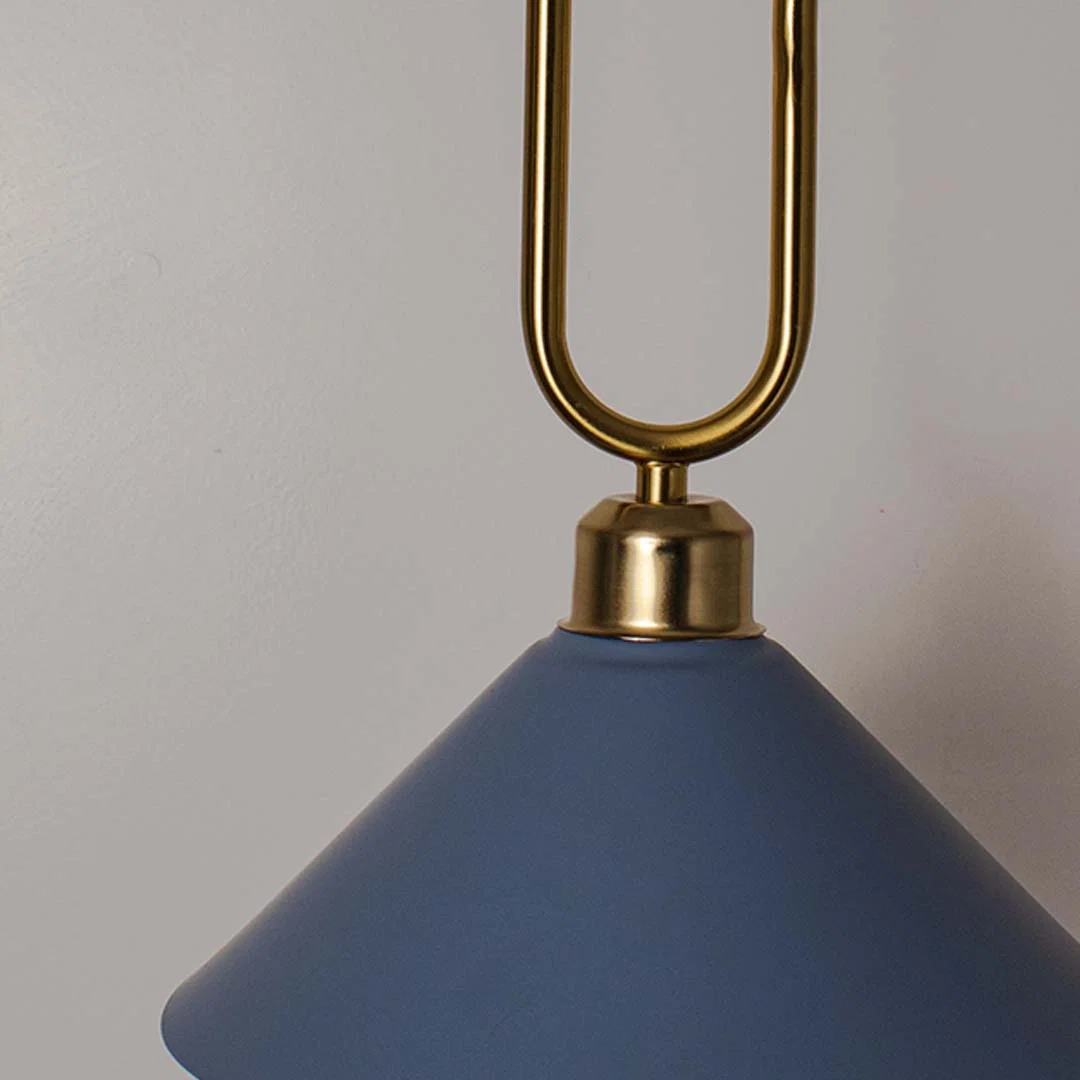 Closeup of blue metal pendant light with gold loop accent highlighting premium finish and design.