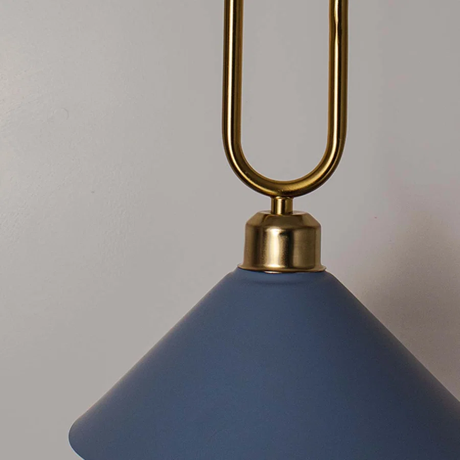Closeup of blue metal pendant light with gold loop accent highlighting premium finish and design.
