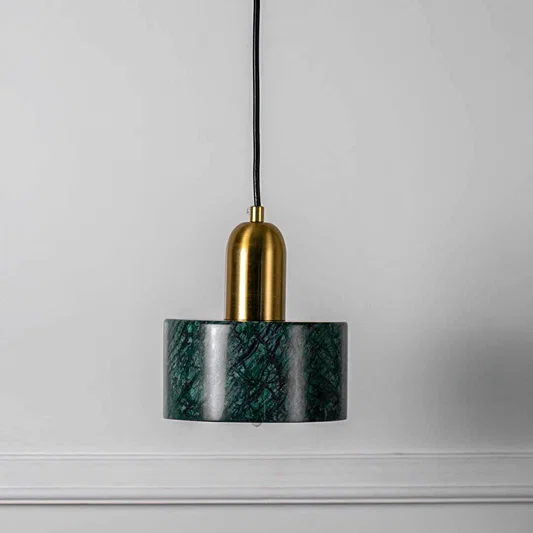 Green textured glass pendant light with gold fixture and hanging cord placed against neutral wall background enhancing elegant contemporary lighting decor appeal.