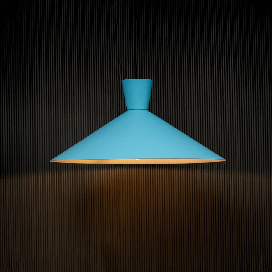 Modern blue metal pendant light turned on with a wide cone shaped shade casting a warm downward glow ideal for contemporary home décor.