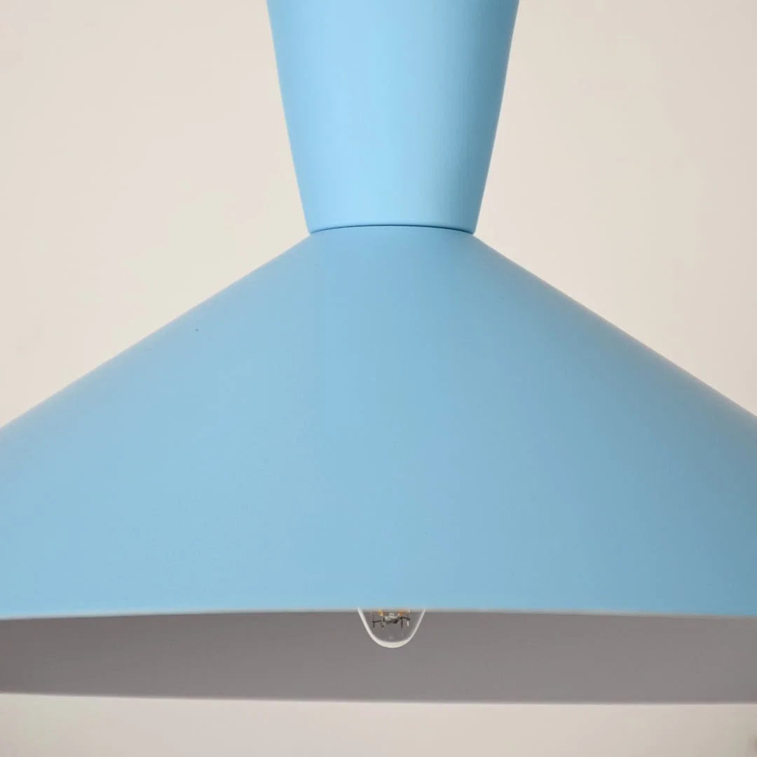 Blue metal pendant light closeup highlighting smooth finish and premium modern lighting craftsmanship details.
