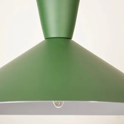 Green metal pendant light closeup highlighting smooth finish and premium modern lighting craftsmanship details.
