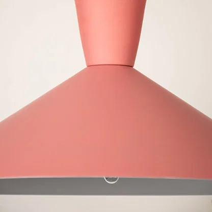 Pink metal pendant light illuminated to showcase modern ceiling lighting with stylish contemporary decorative appeal.