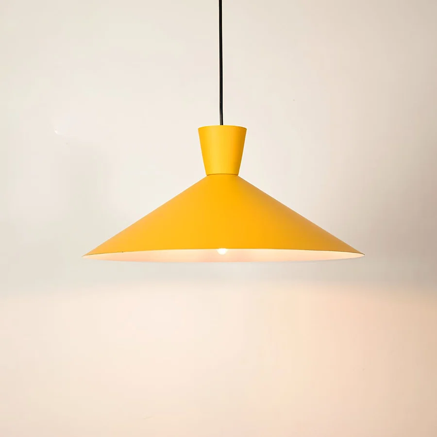 Yellow metal pendant light illuminated to showcase modern ceiling lighting with vibrant contemporary decorative appeal.