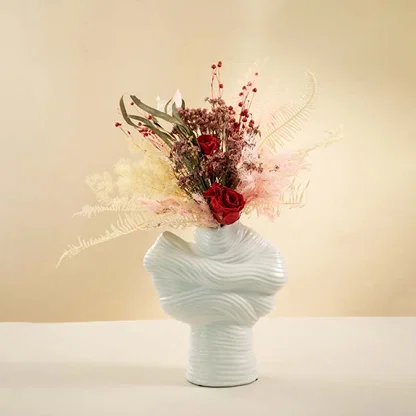Textured white ceramic vase styled on neutral background casting soft shadows for artistic home interior decor.
