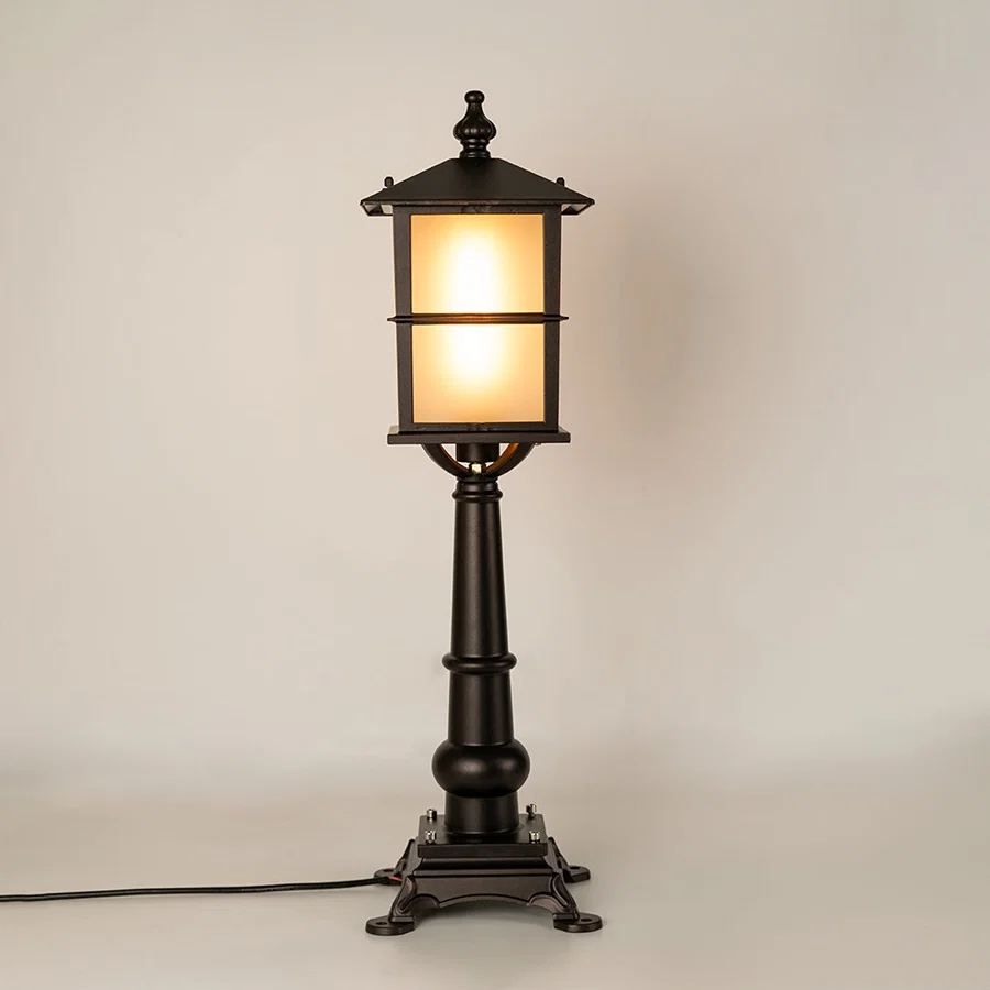 Vintage black outdoor garden light with warm glowing panels for luxury exterior decor styling use.