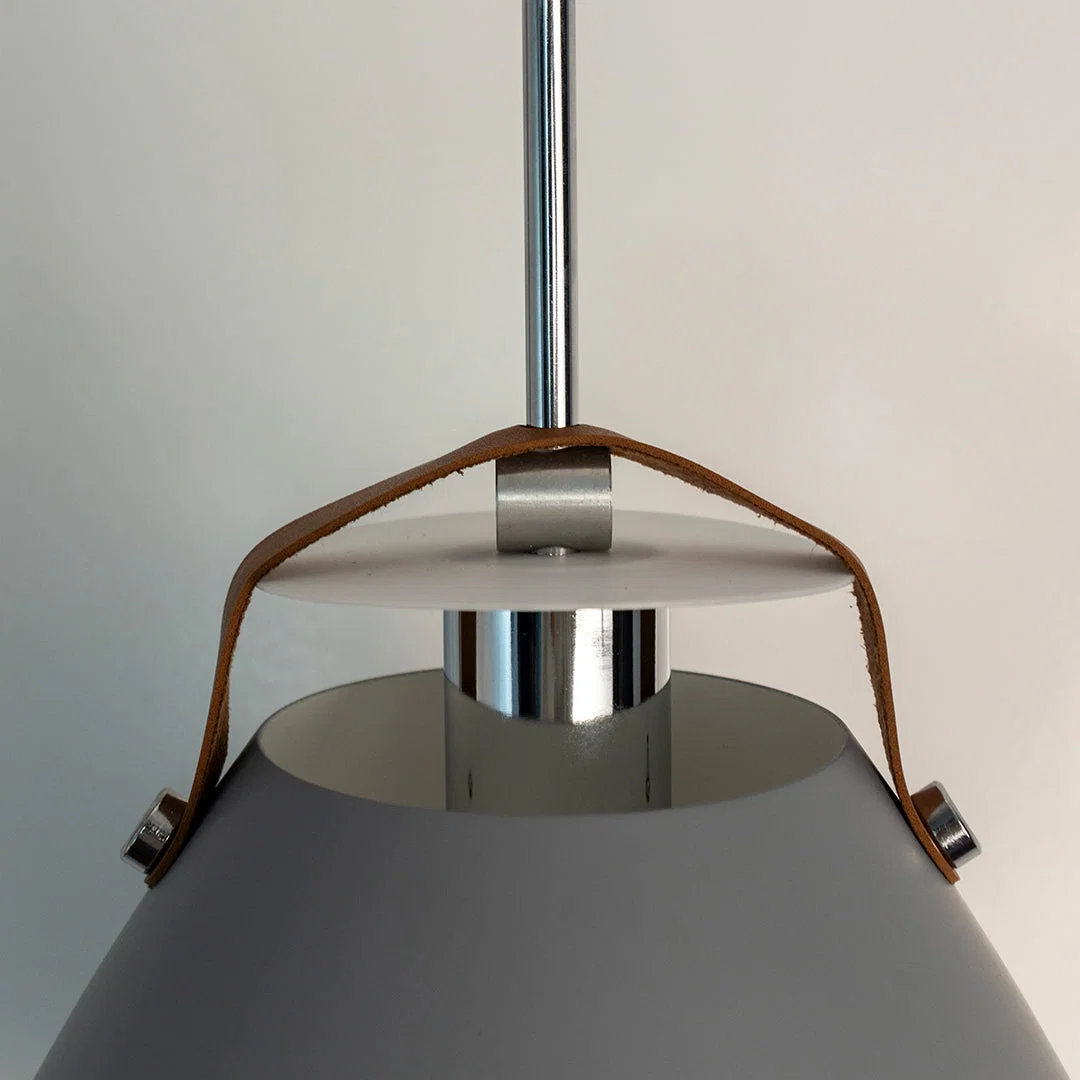 Detailed view of grey metal pendant light with polished steel accents highlighting refined craftsmanship.