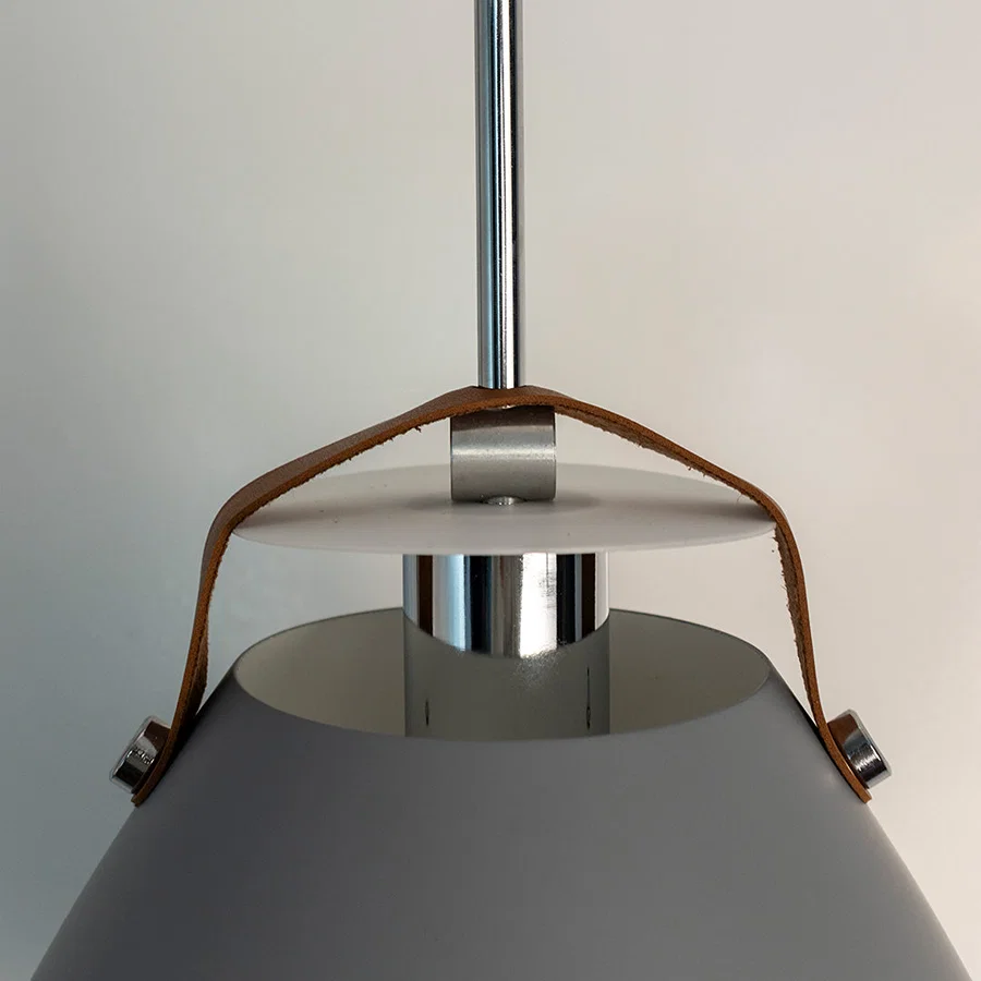 Detailed view of grey metal pendant light with polished steel accents highlighting refined craftsmanship.