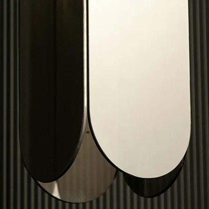 Closeup of black metal wall light with smooth finish showcasing modern luxury bedroom lighting.