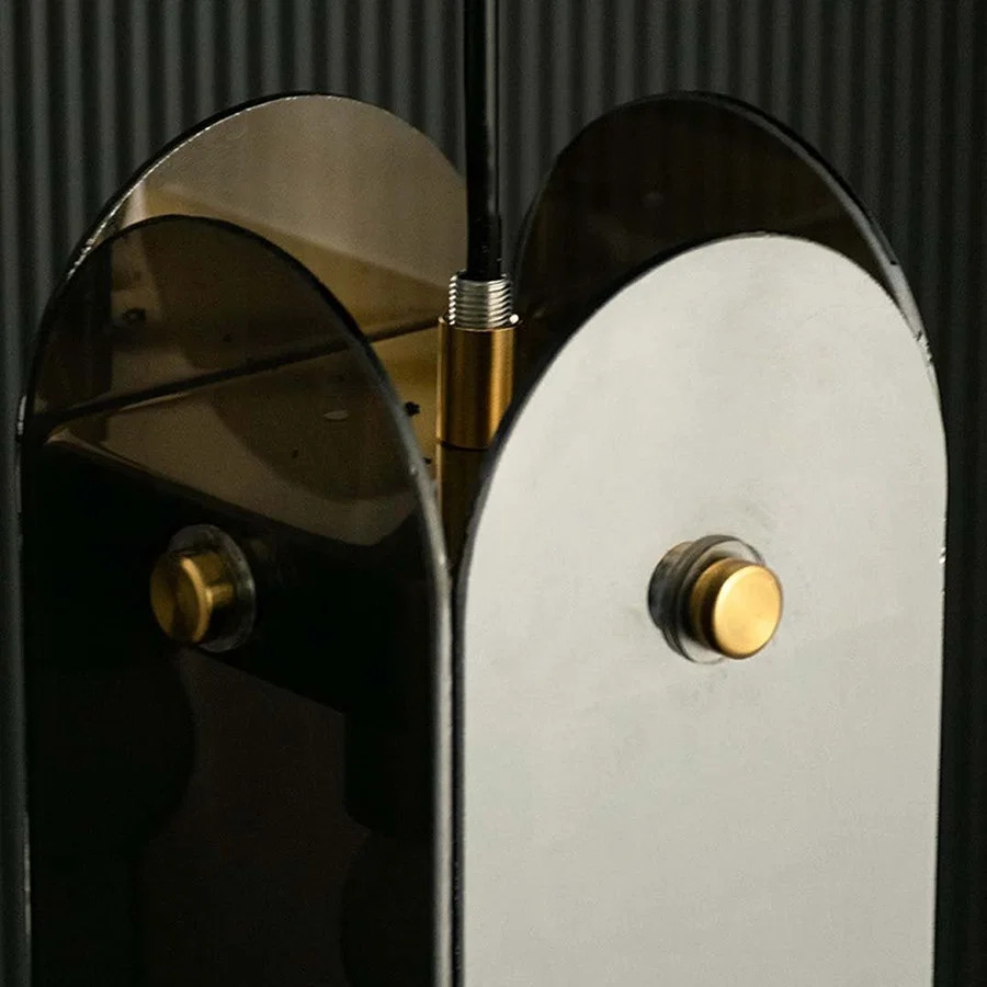 Closeup view capturing smoked glass panels and gold frame details highlighting premium finish smooth curves and high quality craftsmanship.
