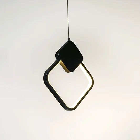 Black geometric pendant light with angular frame and hanging cord placed against neutral wall background highlighting modern artistic lighting design.