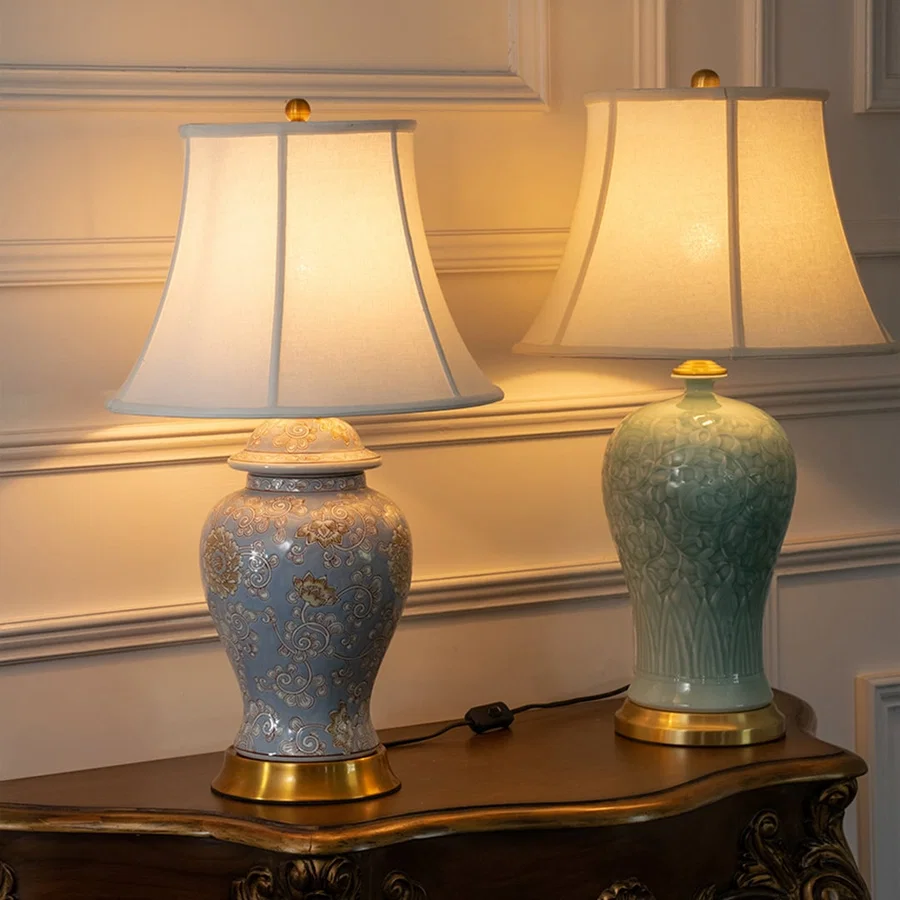 Blue and green ceramic table lamps with fabric shades styled on a console table creating elegant classic decor lighting.