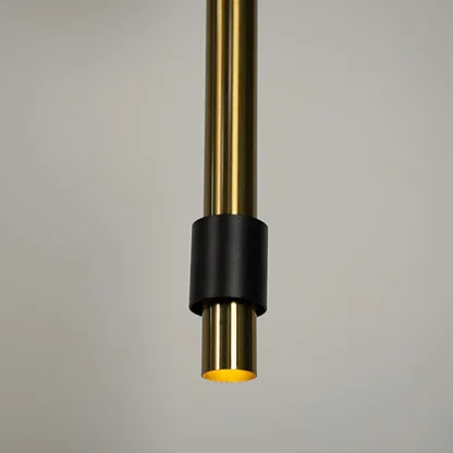 Closeup of black and brass cylindrical pendant light highlighting sleek detailing and craftsmanship.