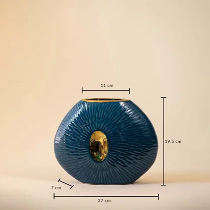 Blue oval ceramic vase with gold accent featuring 19.5 cm height  27 cm width  and 7 cm depth displayed on beige background.