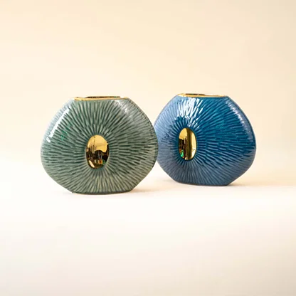 Set of blue ceramic decorative vases with textured patterns and gold accents for luxury contemporary home decor.