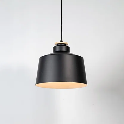 Black metal pendant light with matte finish and industrial drum design for contemporary ceiling lighting decor.