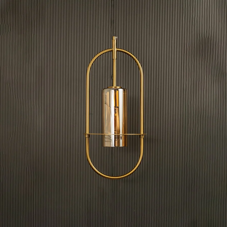 Unlit pendant lamp set against a dark backdrop revealing its modern oval silhouette and subtle metallic sheen.