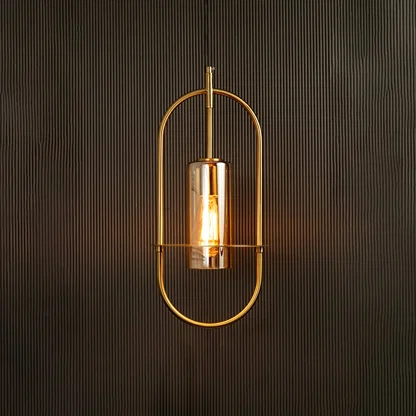 Hanging pendant light illuminated against a dark background emphasizing its curved metal frame and warm amber-toned light.