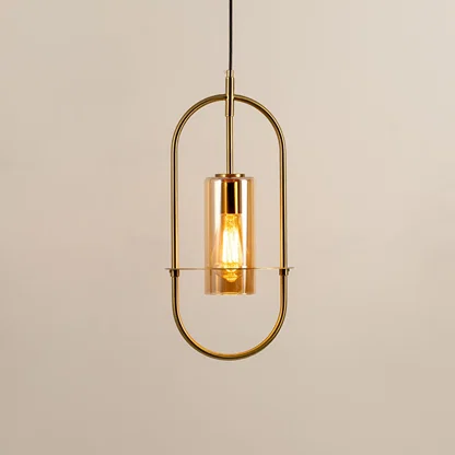Gold metal wall light with clear glass shade illuminated to showcase elegant modern wall lighting design.