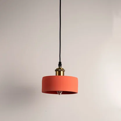 Terracotta orange metal pendant light with cylindrical shade crafted for modern kitchens and dining spaces.