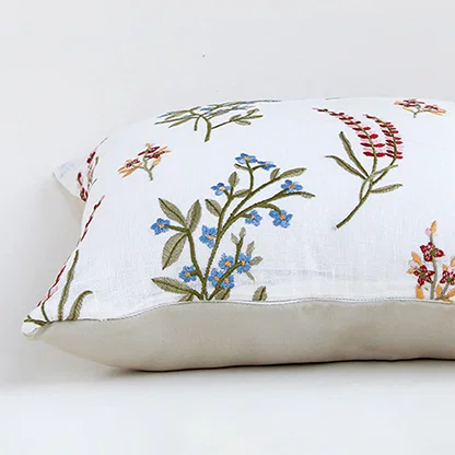 Closeup view of cotton cushion embroidery showing colorful stitched floral patterns and textured fabric details ideal for adding soft charm to home decor.