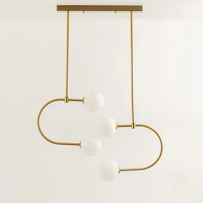 Gold metal pendant light with white glass globes illuminated to showcase modern decorative ceiling lighting elegance.