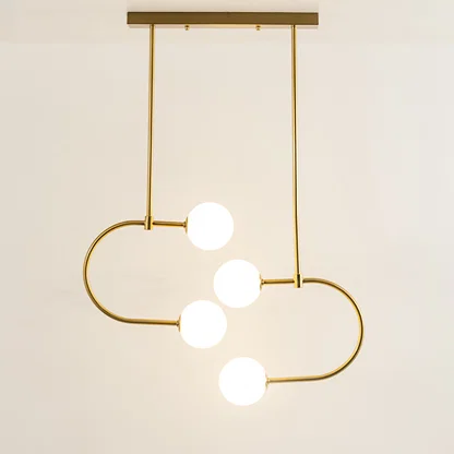 Modern gold metal ceiling light with white glass globes and curved frame emitting soft glow ideal for dining or living room decor.