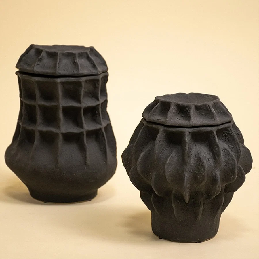 Collection of black matte vases with bold textures styled together for a modern home decor presentation.