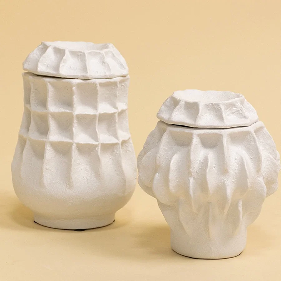 Set of white sculptural vases in modern organic shapes arranged together for a refined artistic decor display.