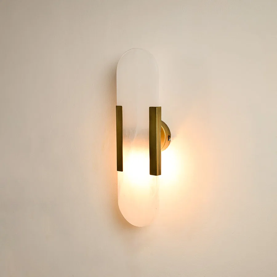 Modern marble and gold wall light with warm ambient glow for premium hallway and luxury decor spaces.


