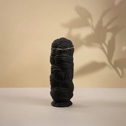 Black ceramic decorative sculpture with layered textured silhouette for modern tabletop styling and artistic home decor.