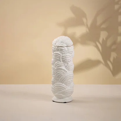 White ceramic decorative sculpture with organic textured silhouette for artistic tabletop styling and home decor.
