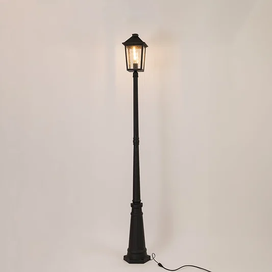Vintage black outdoor street lamp with glowing lantern for luxury exterior decor styling use.