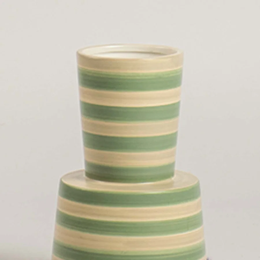 Closeup view of a green and beige striped ceramic vase highlighting its smooth texture  tapered form  and clean handcrafted detailing.