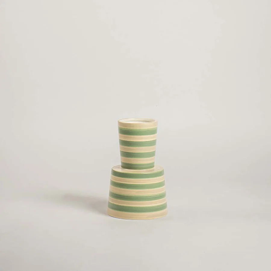 Small green and yellow horizontal striped hourglass totem vase on white background for playful modern interior styling
