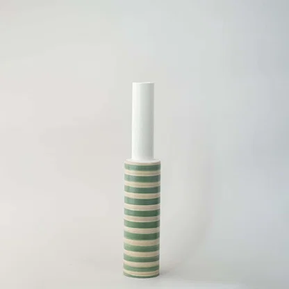 White and green striped ceramic decorative vase with tall silhouette for shelf styling and modern home decor.