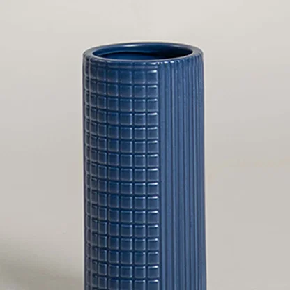Closeup of blue ceramic decorative vase with textured grid design highlighting premium craftsmanship and modern decor.