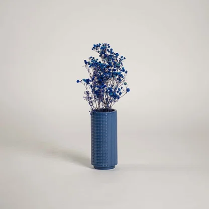 Tall blue ceramic textured vase placed in a modern interior setting perfect for living rooms hallways and stylish home accents.