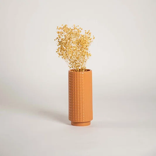 Tall terracotta ceramic textured vase styled in a warm interior space perfect for living rooms hallways and cozy decor accents.