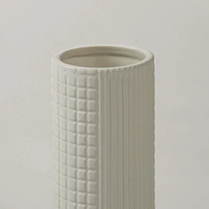 Closeup of ivory ceramic decorative vase with textured grid pattern showcasing refined craftsmanship and modern styling.