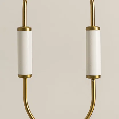 Gold metal wall light closeup highlighting curved frame detailing and premium contemporary lighting craftsmanship quality.