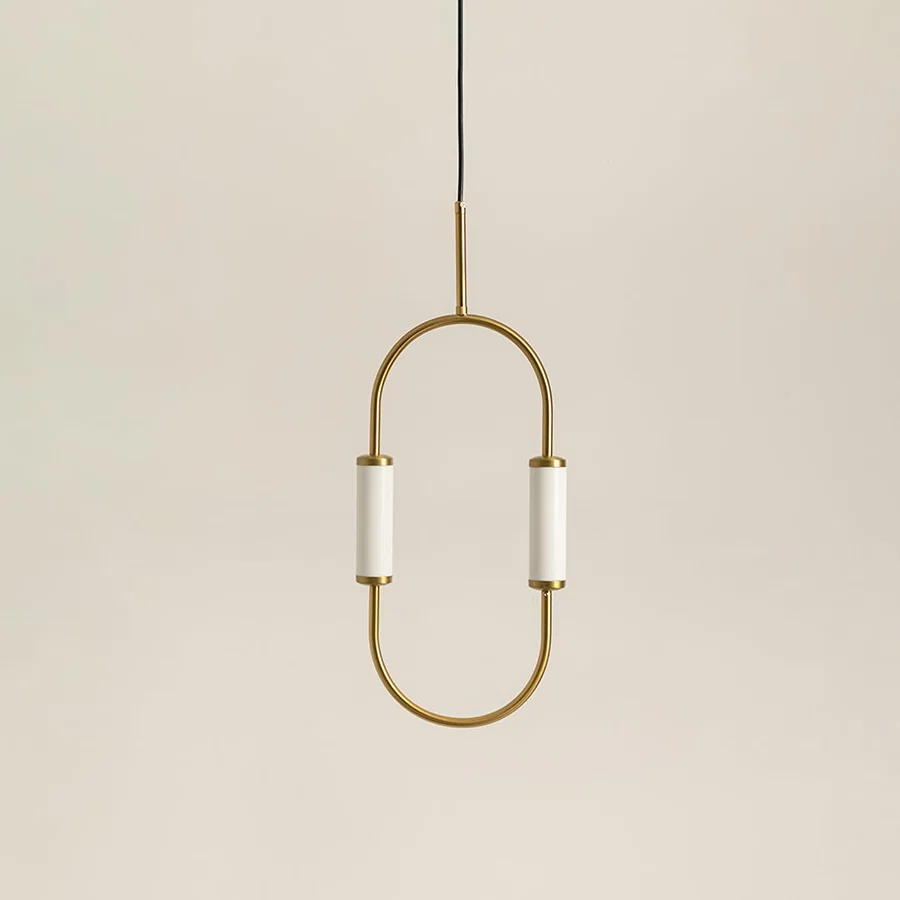 Gold metal wall light with frosted diffuser illuminated to showcase elegant modern decorative wall lighting design.