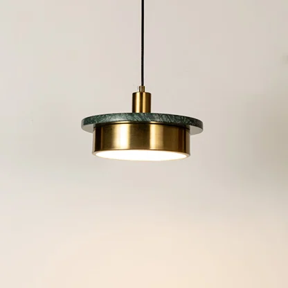 Gold metal pendant light illuminated with sleek cylindrical design highlighting contemporary hanging light craftsmanship.