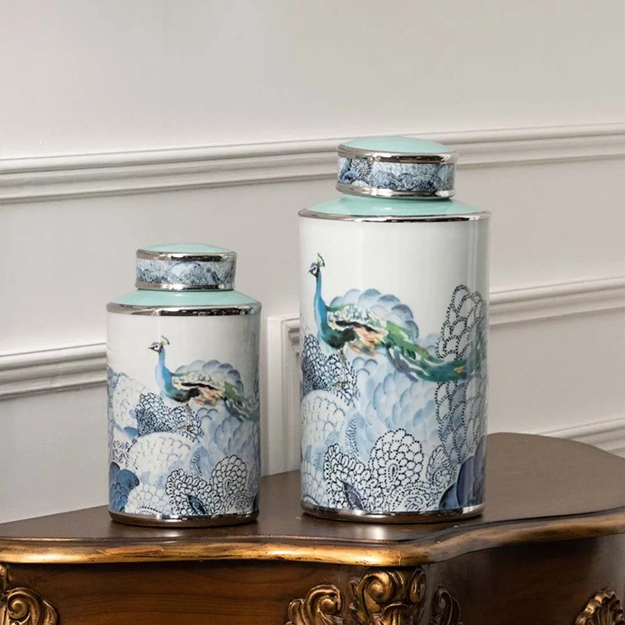 White ceramic jars with blue scenic artwork perfect for sophisticated living room décor and decorative display styling.