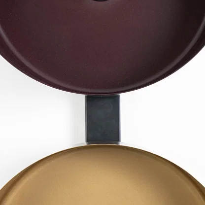 Top-down view of bronze and gold wall shades aligned on black frame showing texture and alignment detail.