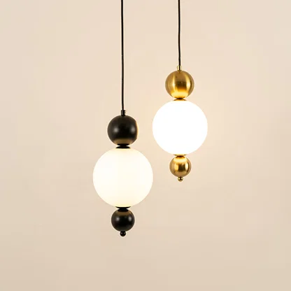 Black and gold metal wall lights illuminated to showcase sophisticated modern wall lighting with refined elegance.