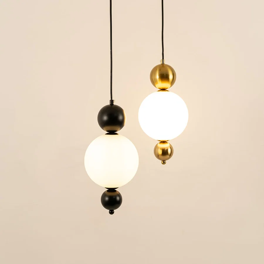 Black and gold metal wall lights illuminated to showcase sophisticated modern wall lighting with refined elegance.