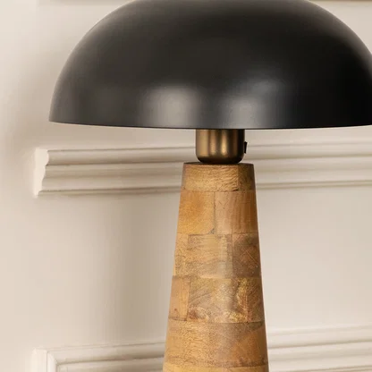 Modern black metal table lamp with wooden base for stylish bedroom and luxury interior decor styling.